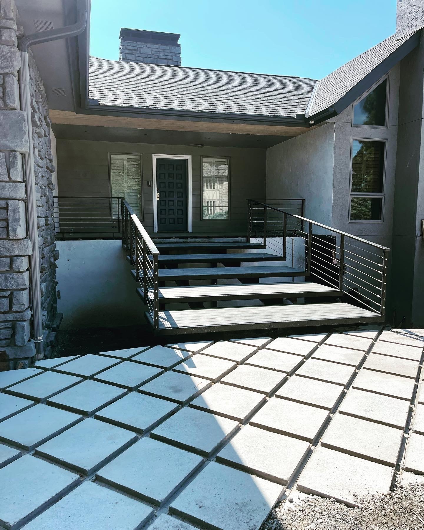 Exterior steel entry stairs and cable railing by Claudio Welding